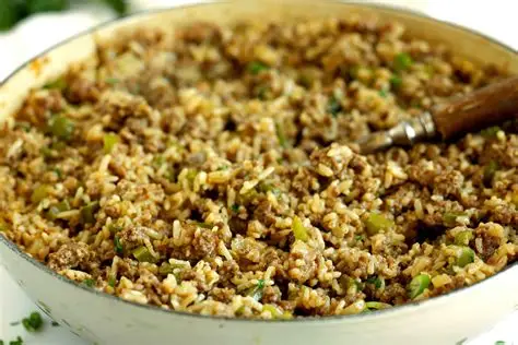 “Homestyle Southern dirty rice made with chicken giblets, onions, celery, bell pepper, and herbs, served in a bowl with rich Cajun-style seasoning.”